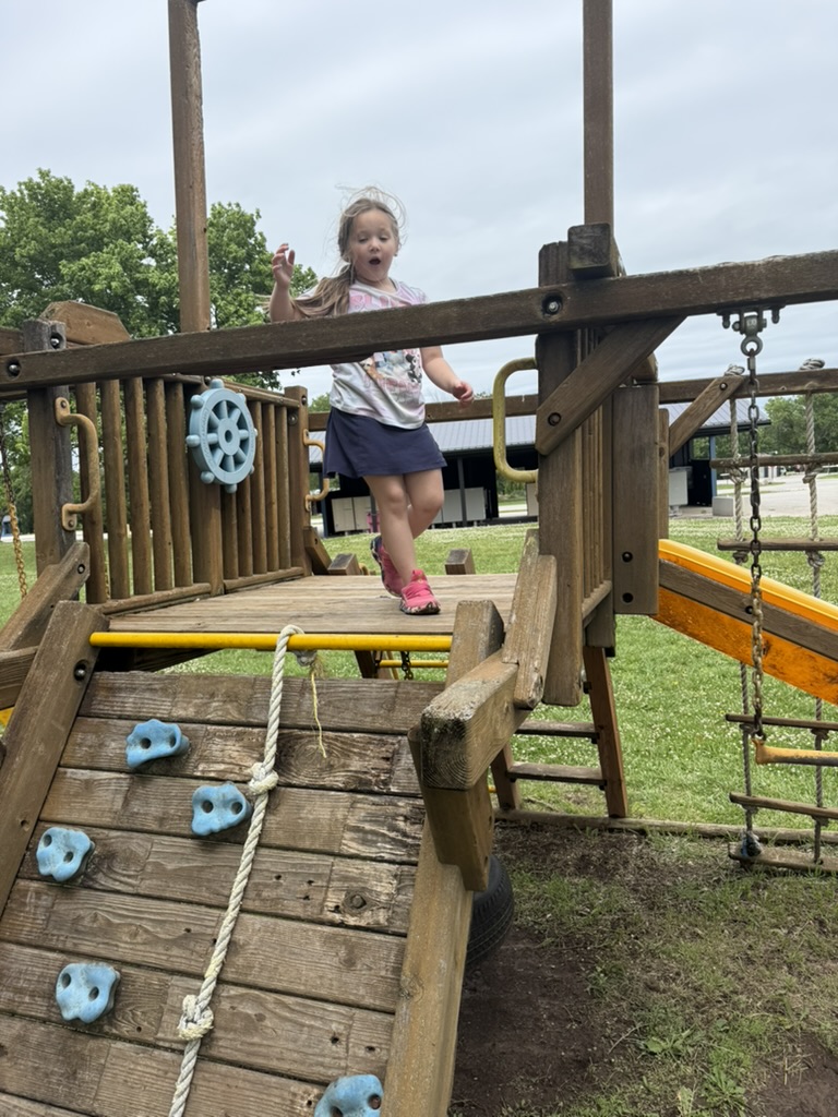 My granddaughter enjoying the playground next to the mini golf course.